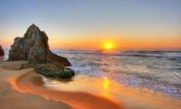 Relaxing campfire at beach sunset