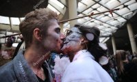 one zombie gives another zombie oral pleasure under the bleachers of a college sports game