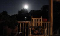 Sitting on the front porch in the evening, reading and drinking.