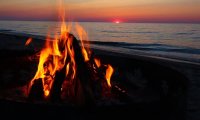 An evening campfire on a lake