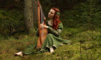 Playing harp near a firecamp