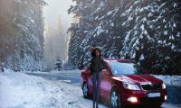 Riding in a car down a snowy road.