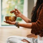 A singing bowl is being used in sound healing therapy